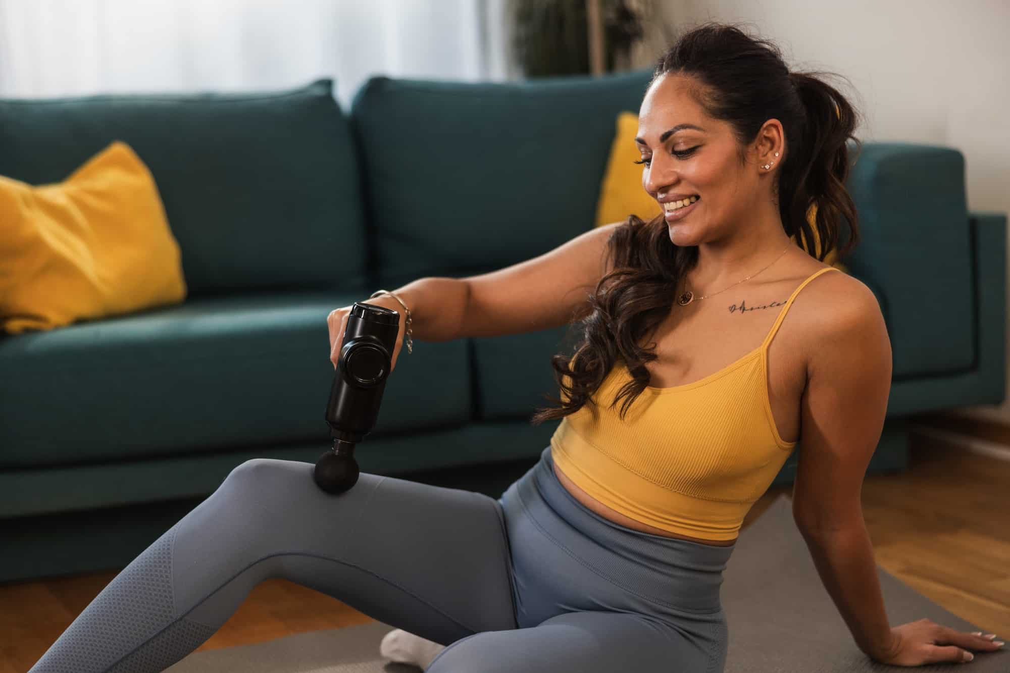 Woman Using A Massage Gun